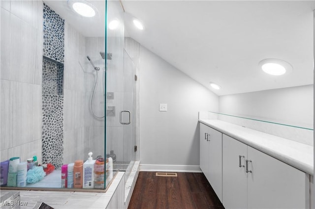 bathroom featuring hardwood / wood-style floors, vanity, and an enclosed shower