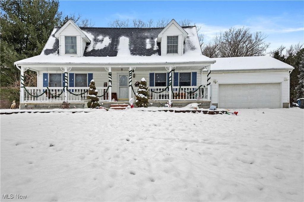 cape cod-style house featuring a garage