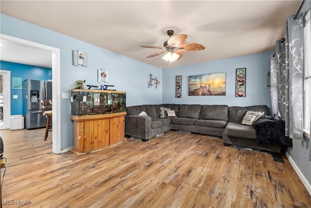 living room featuring hardwood / wood-style floors and ceiling fan