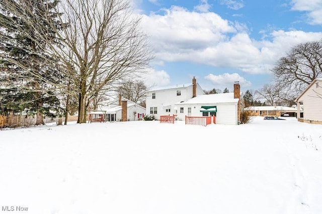 snow covered property featuring a wooden deck