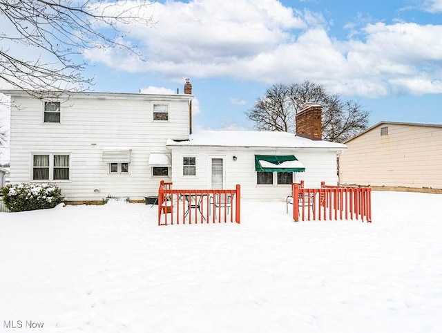 snow covered property featuring a deck