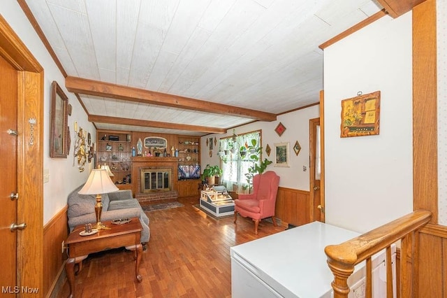 living room with wood ceiling, wooden walls, wood-type flooring, beam ceiling, and built in features