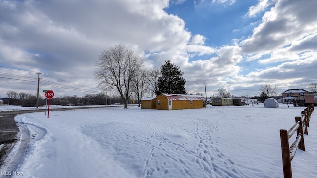 snowy yard with an outdoor structure