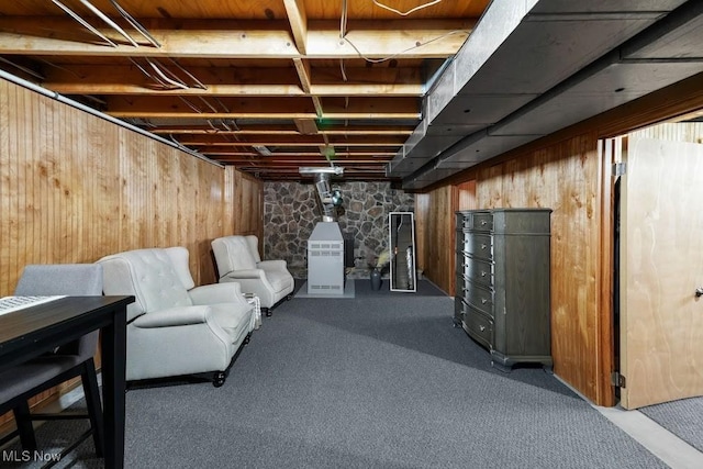 basement with carpet floors and wooden walls