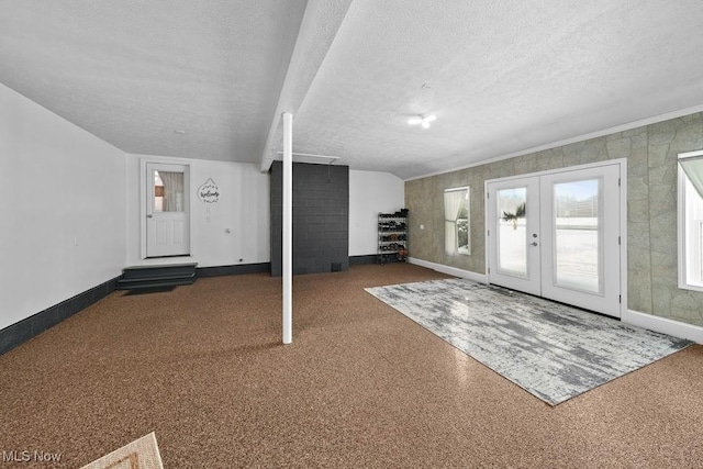 foyer with french doors and a textured ceiling