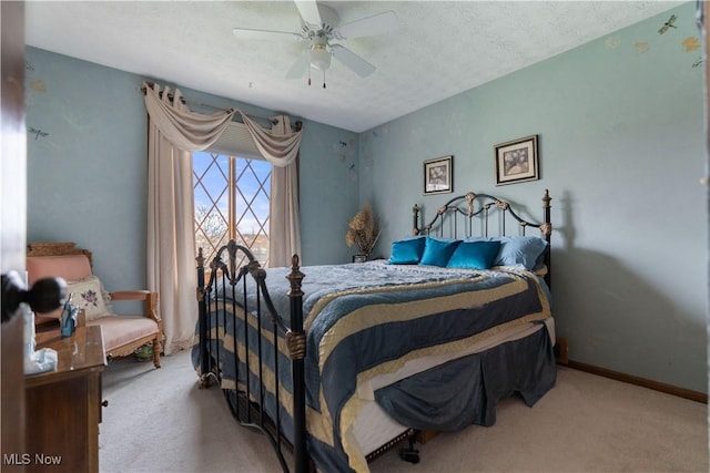 carpeted bedroom featuring a textured ceiling and ceiling fan