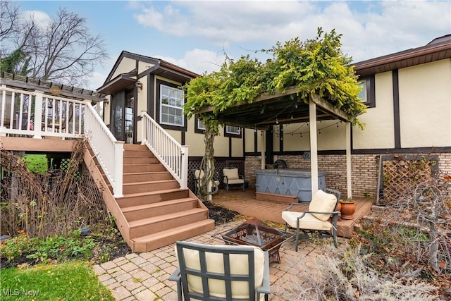 view of patio with a fire pit and a wooden deck