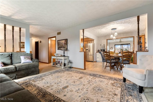 living room with light hardwood / wood-style floors and a textured ceiling