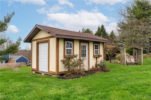 view of outbuilding featuring a yard