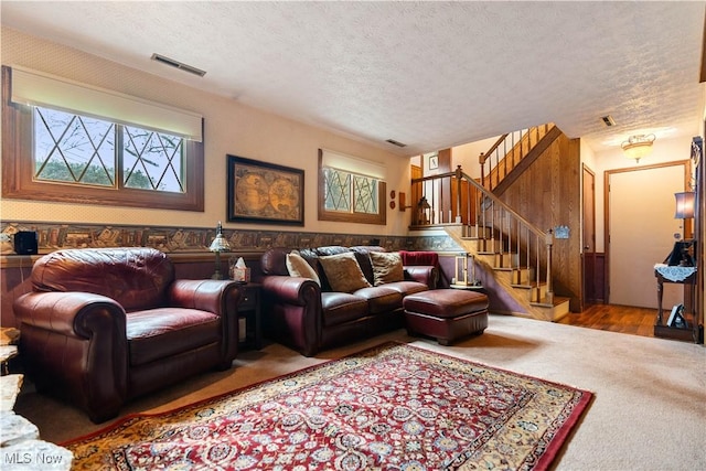 living room with a textured ceiling and carpet floors