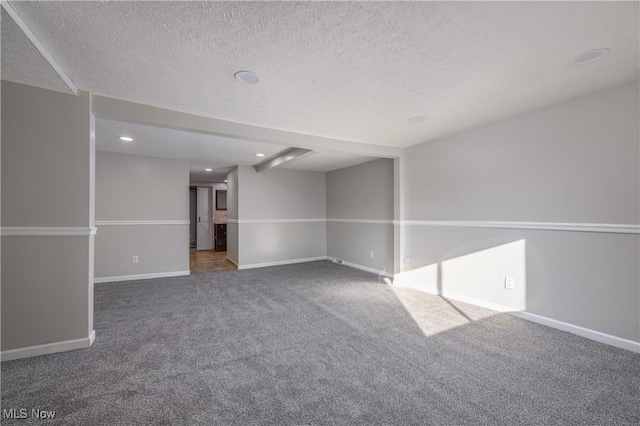 carpeted spare room with a textured ceiling