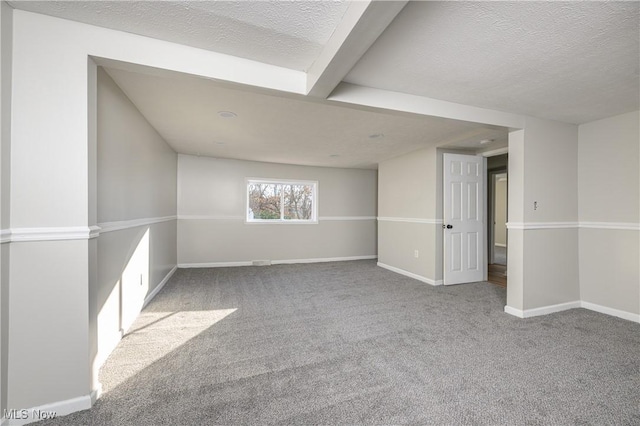 unfurnished room featuring light colored carpet and a textured ceiling