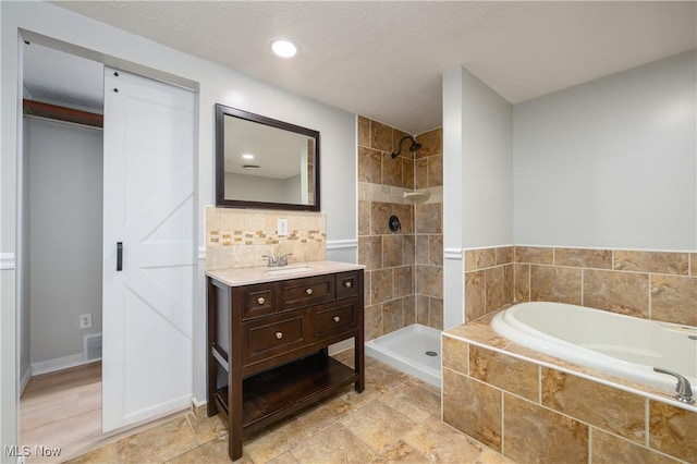 bathroom with vanity and independent shower and bath