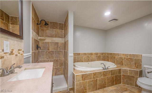 full bathroom featuring vanity, toilet, and independent shower and bath