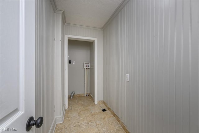 hall with crown molding and a textured ceiling