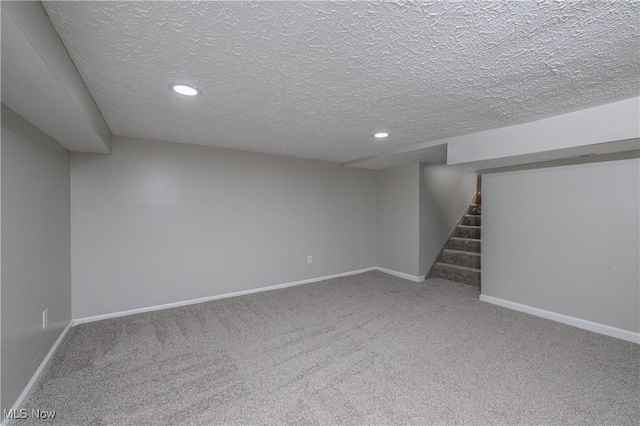 basement featuring carpet floors and a textured ceiling