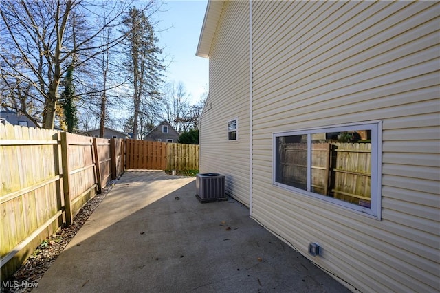 view of side of property featuring a patio area and central air condition unit