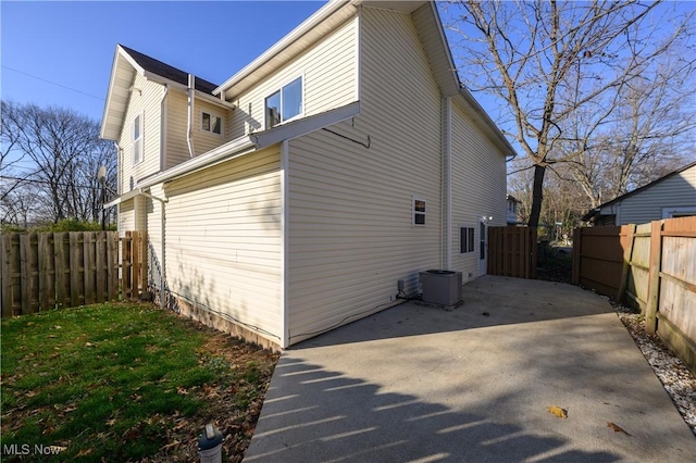 view of property exterior with cooling unit and a patio