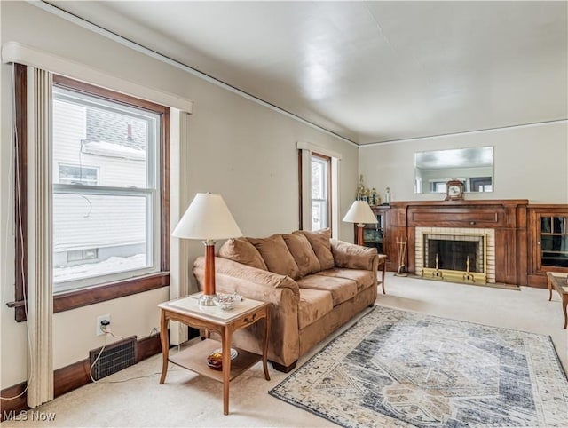 living room with a fireplace and light carpet