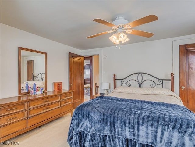 bedroom featuring ceiling fan and light carpet