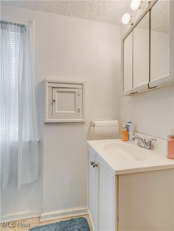 bathroom featuring vanity and a textured ceiling