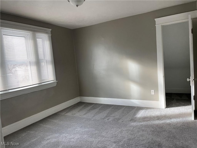 carpeted spare room with a healthy amount of sunlight