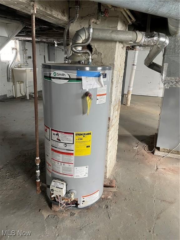 utility room with sink and water heater