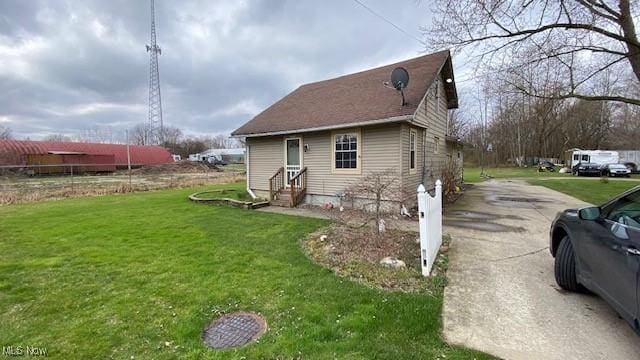 view of side of property with a yard