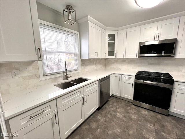 kitchen with white cabinets, light stone counters, sink, and stainless steel appliances