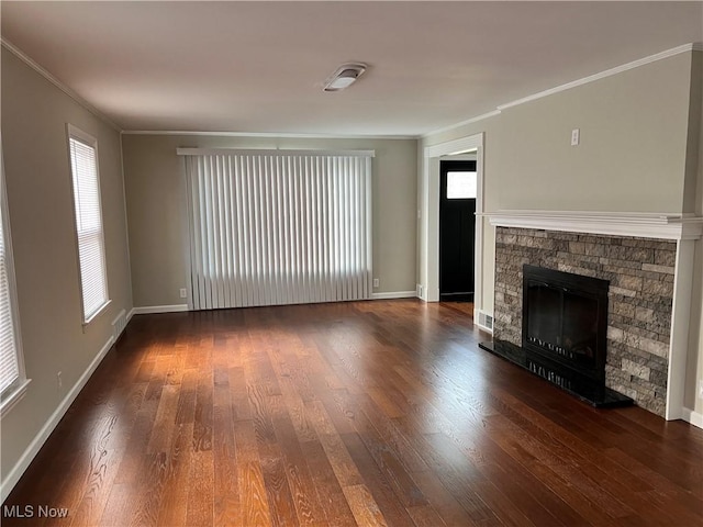 unfurnished living room with dark hardwood / wood-style flooring, ornamental molding, and a fireplace