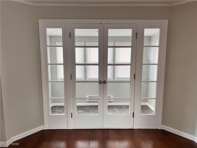 doorway to outside with dark hardwood / wood-style floors, crown molding, and french doors