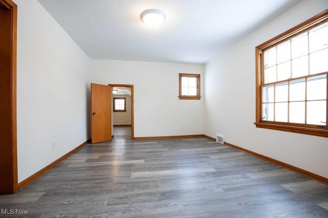 unfurnished room featuring dark wood-type flooring