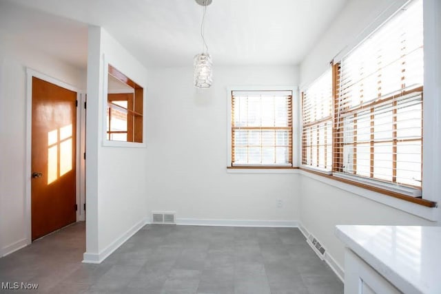 unfurnished dining area featuring a wealth of natural light