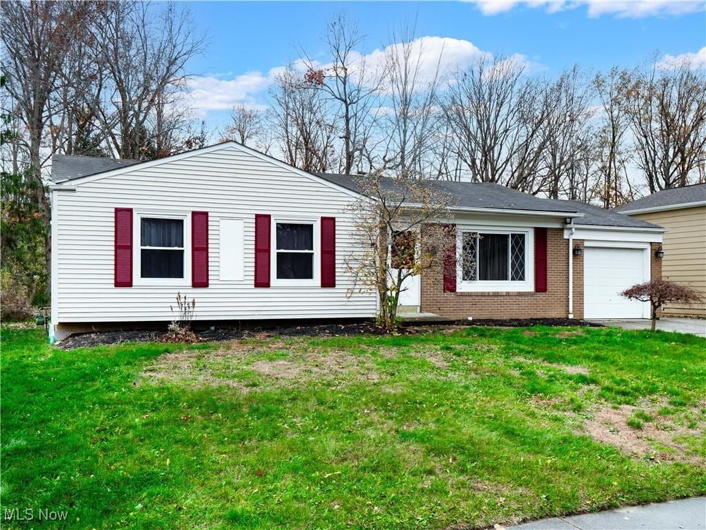 view of front of property featuring a garage and a front yard