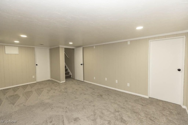 basement featuring carpet flooring and crown molding