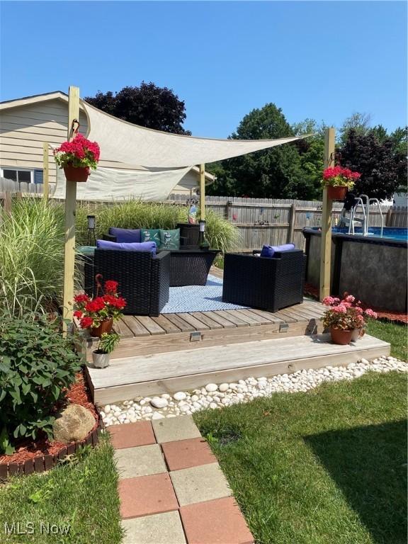 view of yard featuring outdoor lounge area and a wooden deck