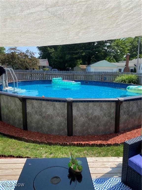 view of swimming pool with a wooden deck