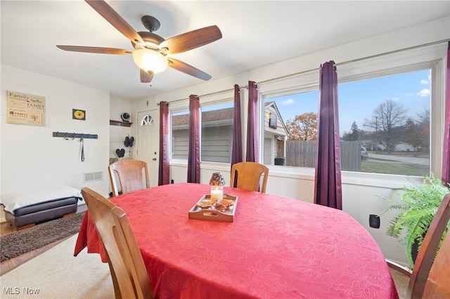 carpeted dining area featuring ceiling fan