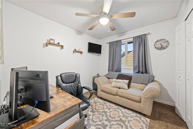 carpeted office space with ceiling fan