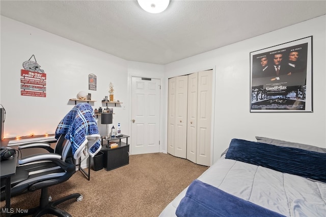 carpeted bedroom featuring a textured ceiling and a closet