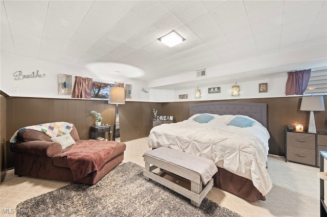 carpeted bedroom with wooden walls