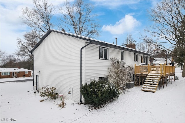 view of snow covered exterior featuring a wooden deck