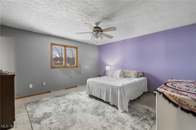 bedroom featuring a textured ceiling, ceiling fan, and a baseboard heating unit