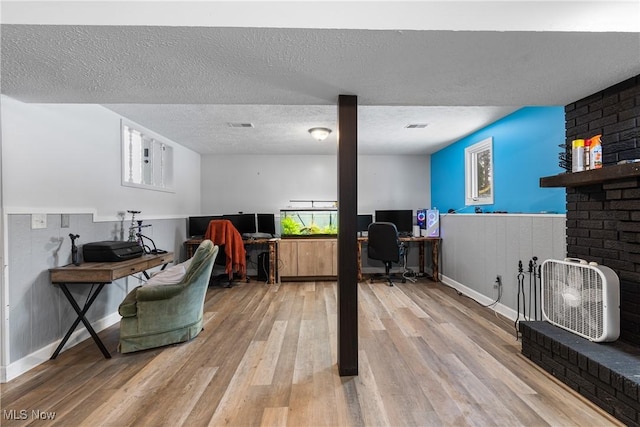 office with hardwood / wood-style flooring and a textured ceiling