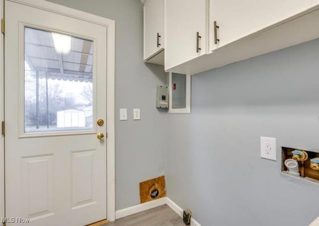 laundry room featuring cabinets and light hardwood / wood-style floors