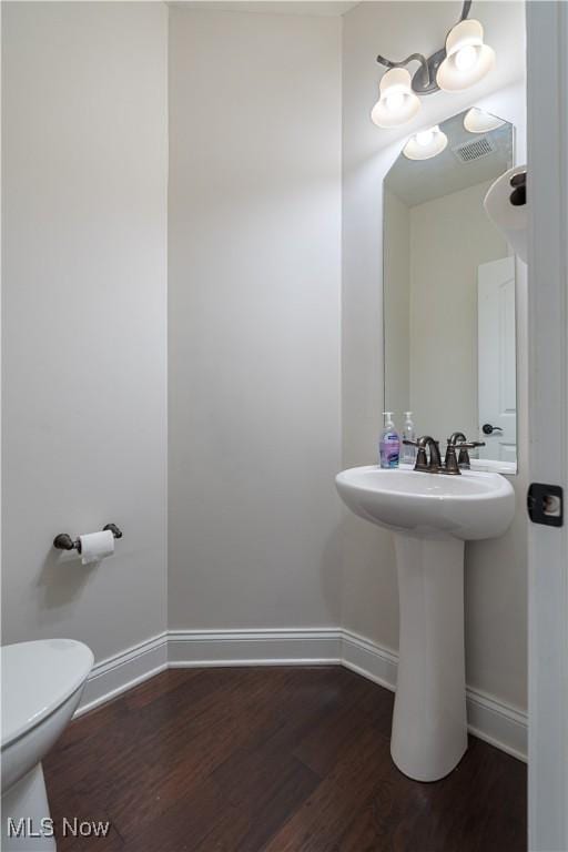 bathroom featuring sink, hardwood / wood-style floors, and toilet