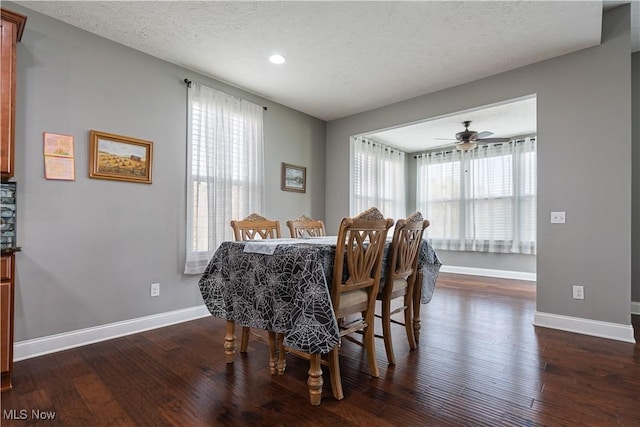 dining area featuring dark hardwood / wood-style flooring, a textured ceiling, and ceiling fan