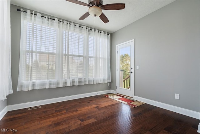 interior space featuring wood-type flooring, a textured ceiling, and ceiling fan