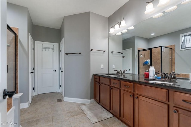 bathroom featuring vanity and an enclosed shower