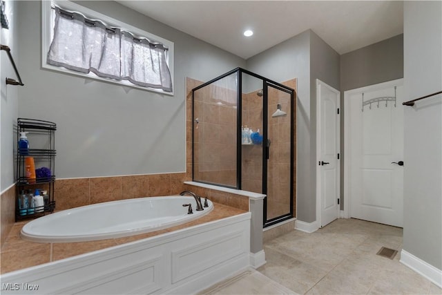 bathroom featuring tile patterned flooring and independent shower and bath